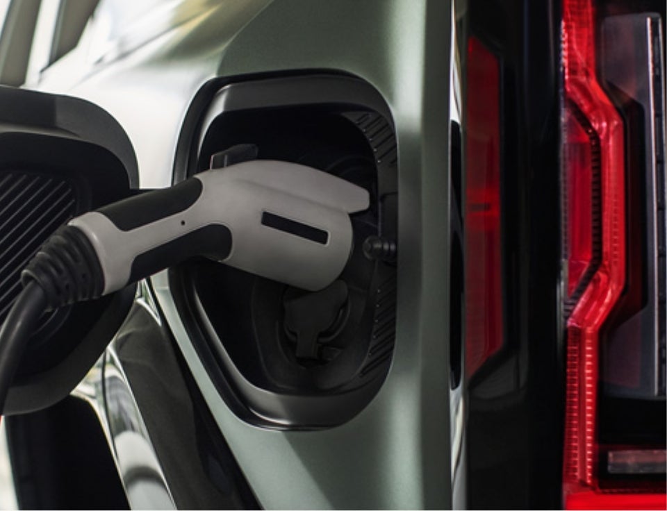 Close up of charging port with charger plugged in on a GMC Hummer EV SUV - Kramer GMC Madisonville in MADISONVILLE TX